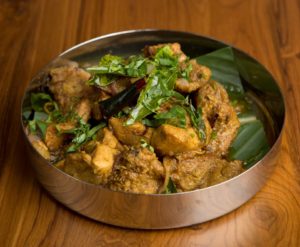 Try the Mangalorean Chicken Ghee Roast at Southern Spice Indian Kitchen at Crossroads in Irvine.