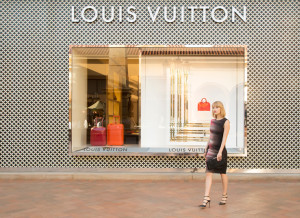 Model walking in front of Louis Vuitton